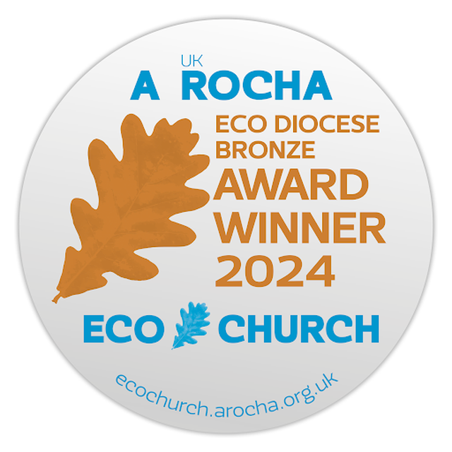 White circular award badge with blue and bronze text and an image of an oak leaf in bronze, stating the Eco Diocese Bronze Award was won in 2024